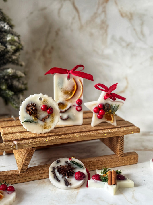 Decorative Christmas ornaments on a wooden stand with a marble background